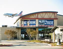 outside of the proud bird restaurant with an airplane flying nearby for the Women In Defense 2020 kick-off mixer.