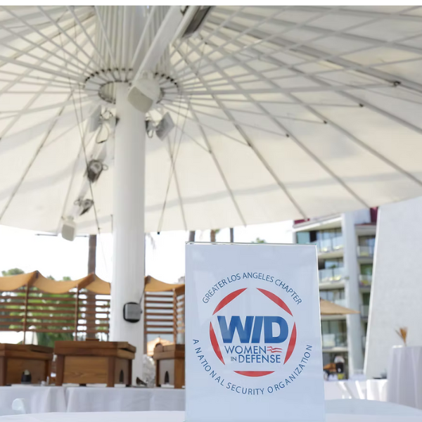 A sign for WID Greater Los Angeles sits on a table at an event.